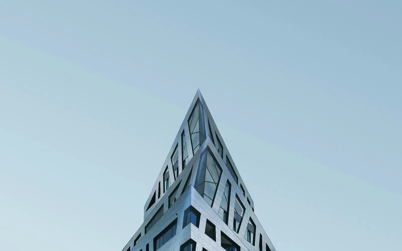 Sculptural concrete architecture against a pale cobalt sky